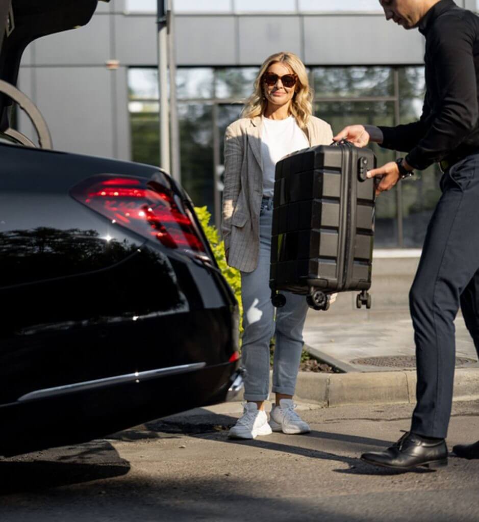 Woman with driver and luggage.