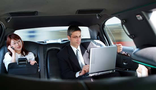 Business people riding in limousine