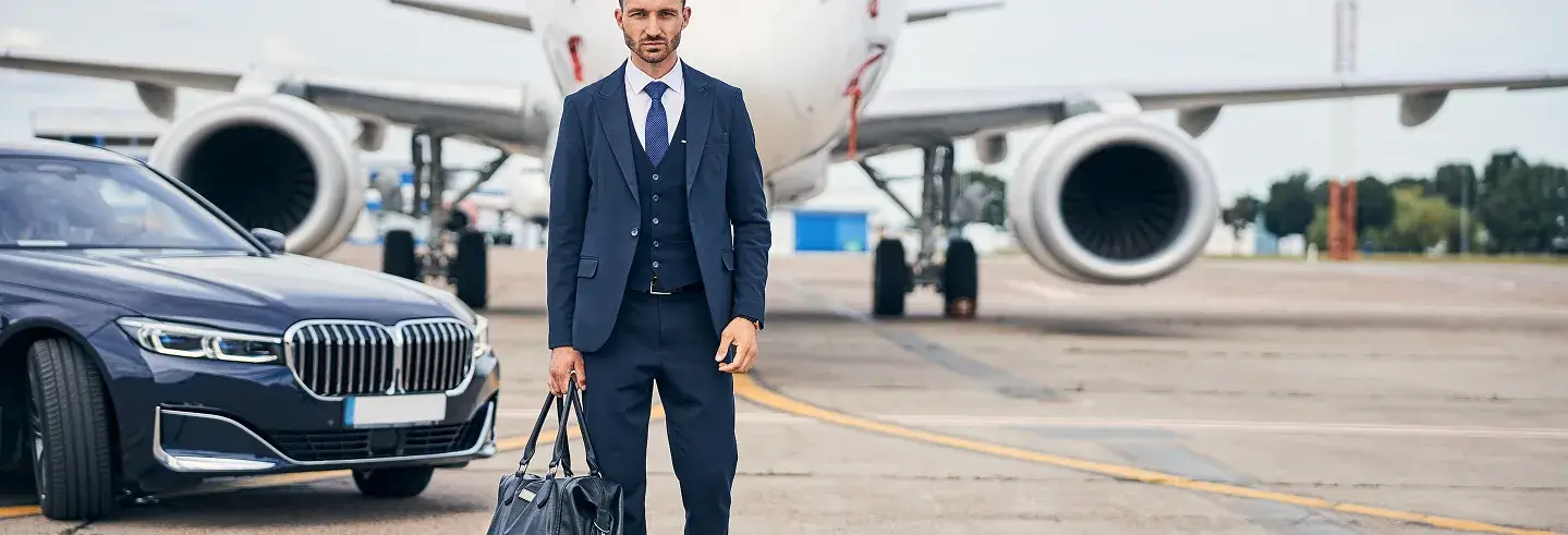 Businessman with bag by private jet.