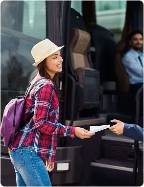 Woman receives bus ticket from driver.