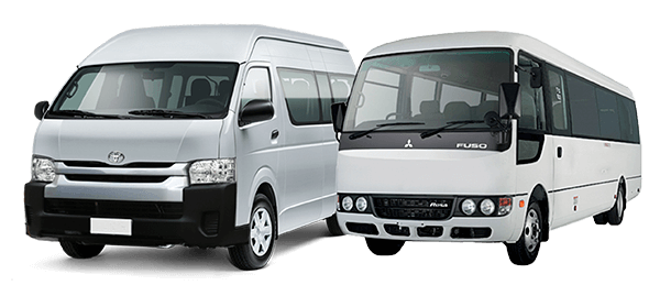 Two white passenger vans parked side by side: a Toyota Hiace on the left and a Mitsubishi Fuso bus on the right.