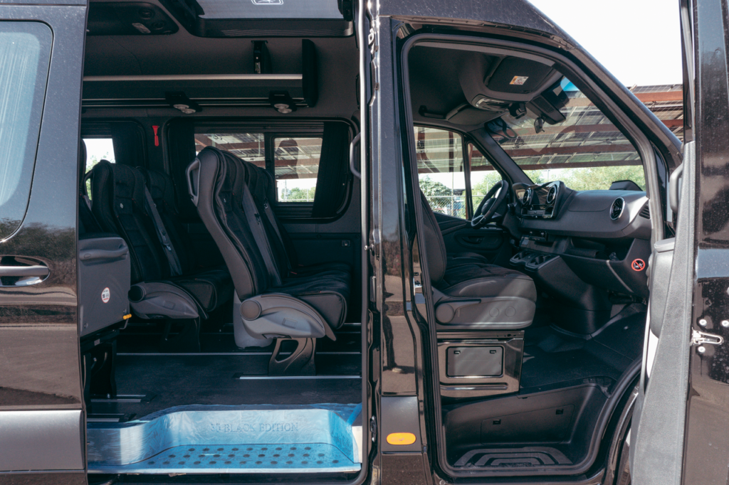 Explore the spacious and luxurious interior of a premium black van, perfect for corporate or VIP transport.